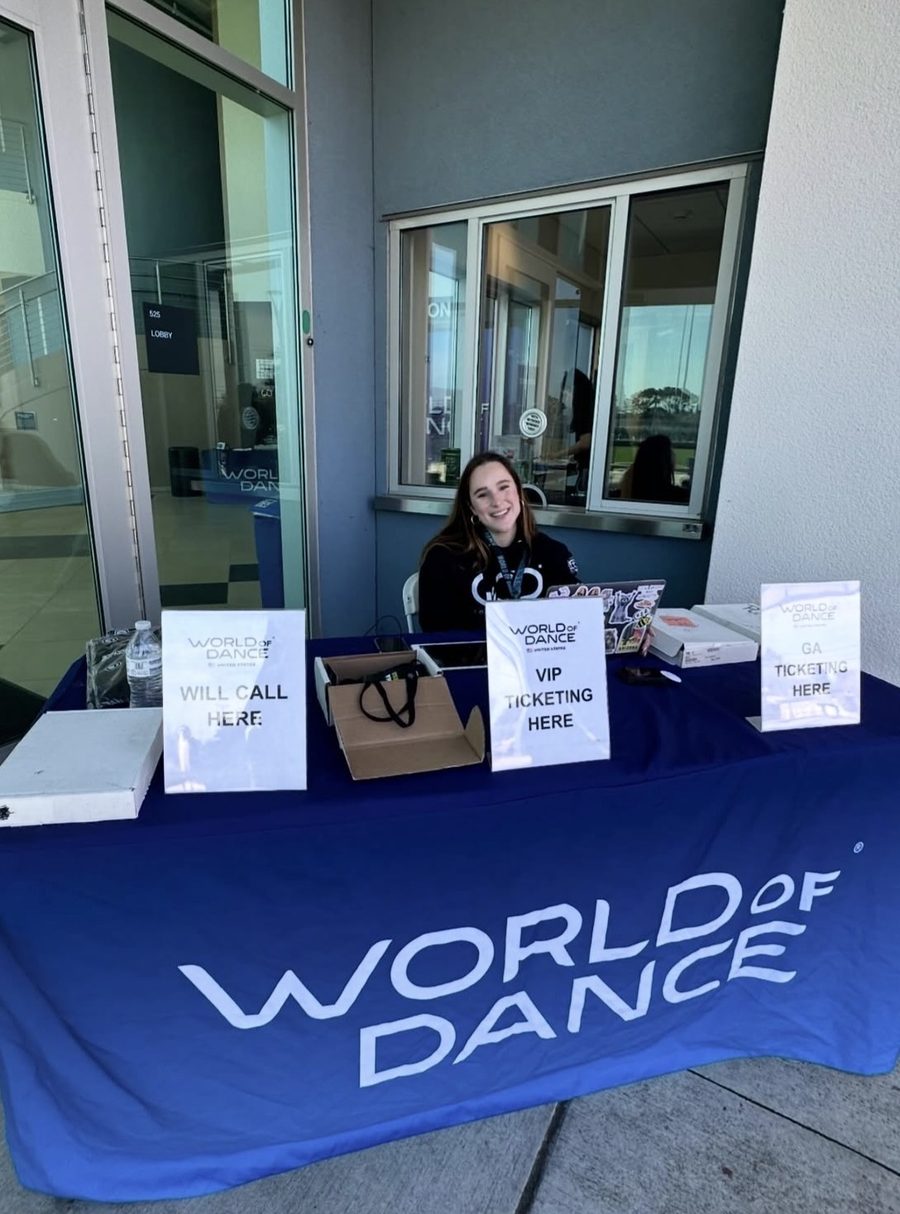 Mia Bella McGarity running the World of Dance box office and ticketing table